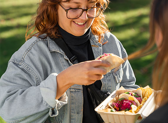 Girl eating tacos from biopak no added pfas assortment